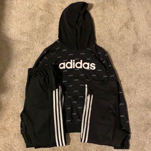 black adidas hoodie with black adida sweat pants and black adida leggings.